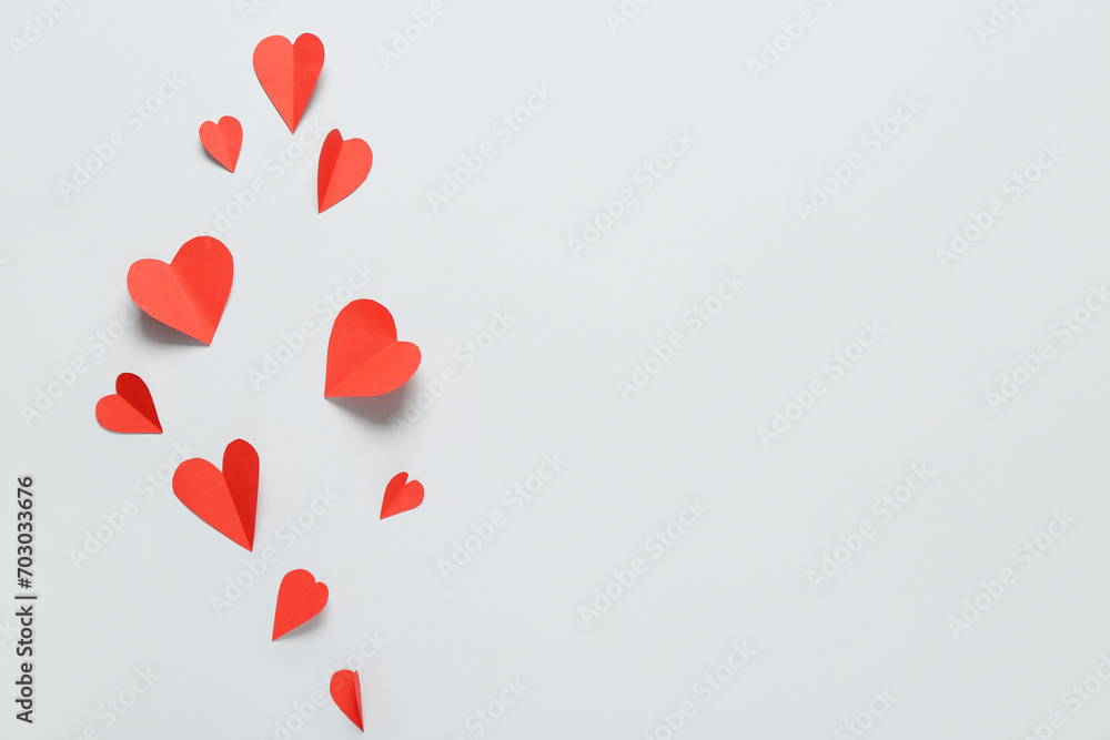 Composition with red paper hearts on grey background. Valentine's Day celebration