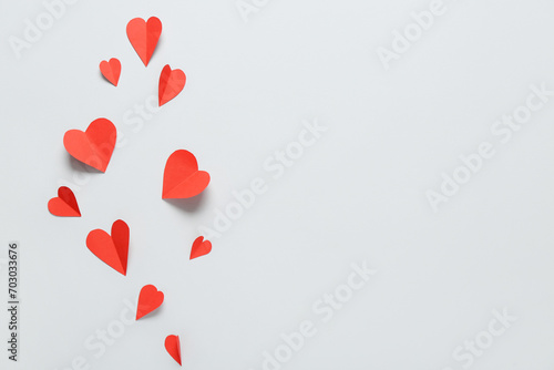 Composition with red paper hearts on grey background. Valentine s Day celebration