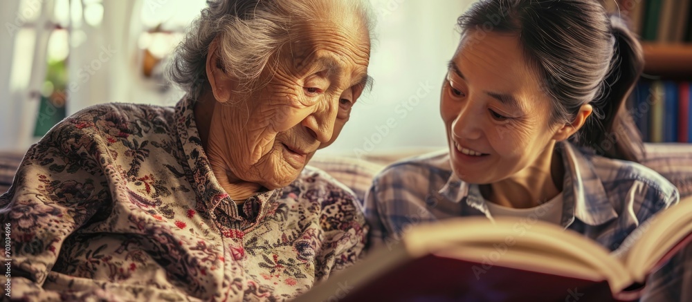 Caregiver supports dementia therapy through book reading with elderly woman.