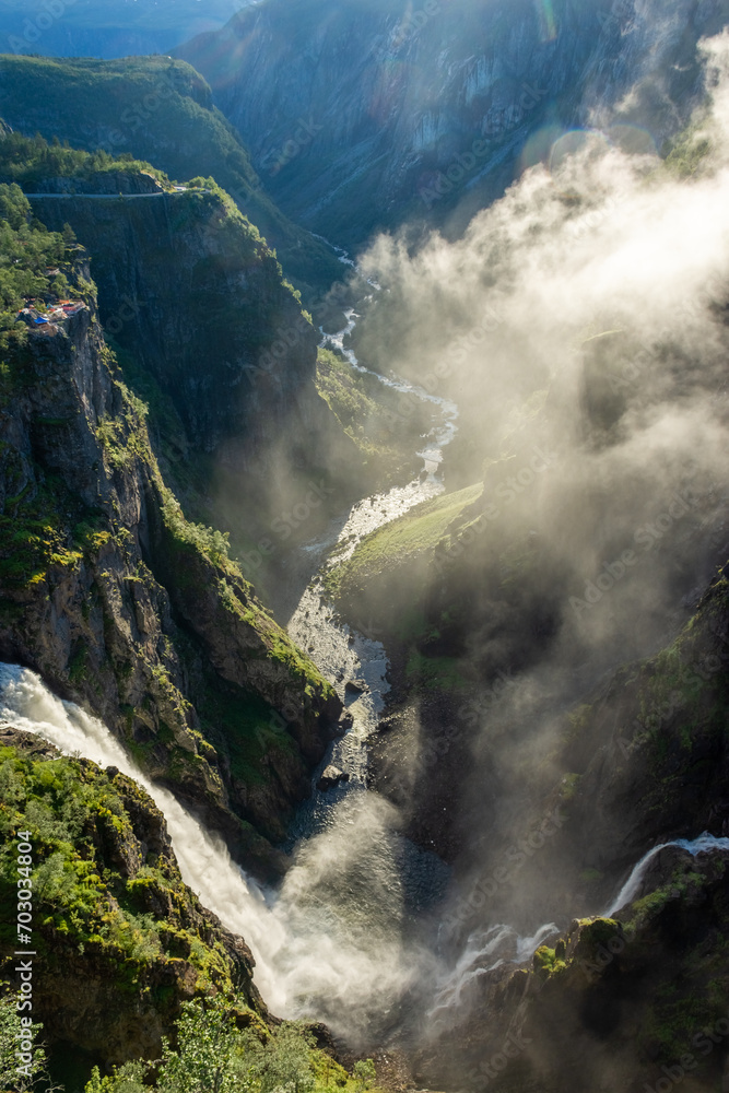 Beautiful view over the misty cliffs of the Voringfossen waterfall, Norway Beautiful view over the misty cliffs of the Voringfossen waterfall, Norway