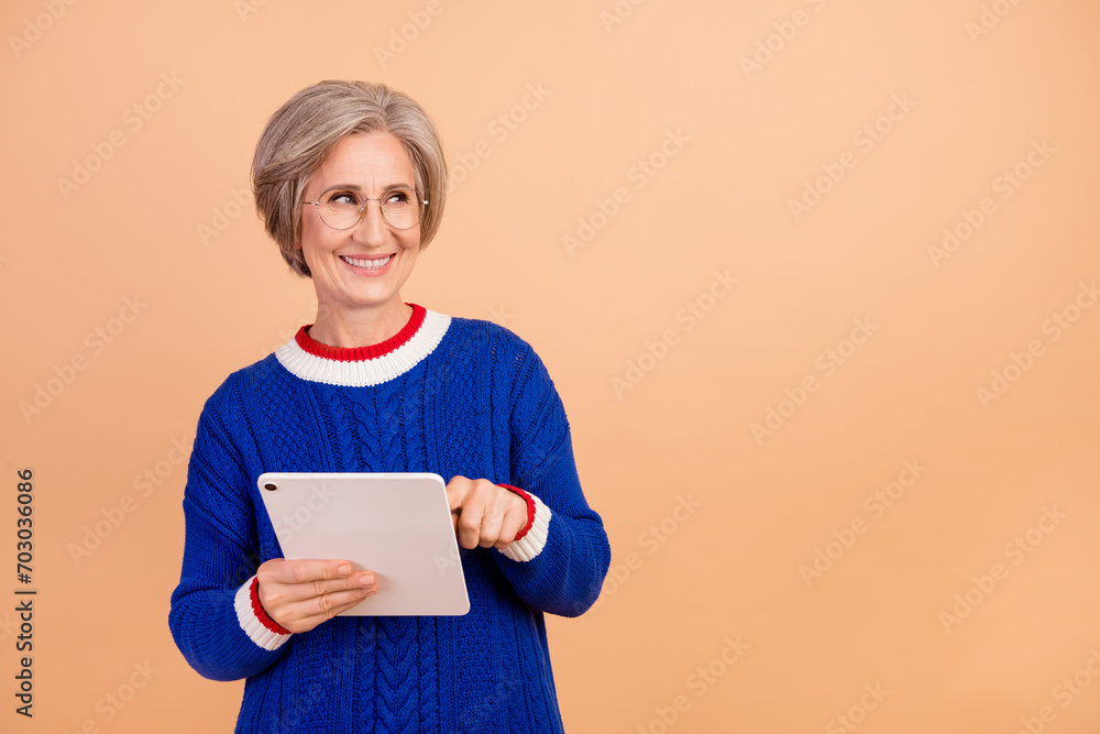 Photo of adorable lovely woman dressed trendy blue clothes looking offer news poster empty space isolated on beige color background Photo of adorable lovely woman dressed trendy blue clothes looking offer news poster empty space isolated on beige color background