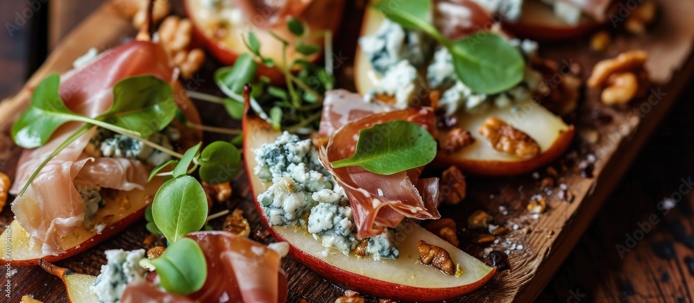 Festive appetizer with pear, prosciutto, and blue cheese.