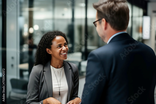 Business meeting between man and woman in office workplace environment interview hire enrol introduce or conclude deal introduce each other in casual happy relaxed atmosphere photo
