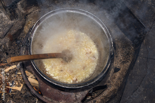 food cooking in stew pot in the nature ,romanian , tocana,traditional ceaun photo