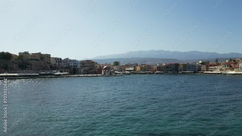 Drone take off, panoramic view over the harbor of Chania on the island of Crete in Greece. Panoramic view from the sky over the city. View of a lighthouse on the sea with cliffs and water waves. Drone take off, panoramic view over the harbor of Chania on the island of Crete in Greece. Panoramic view from the sky over the city. View of a lighthouse on the sea with cliffs and water waves.