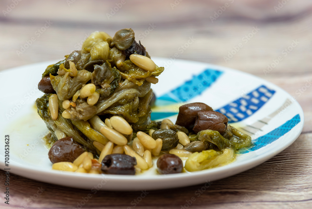 Stewed escarole with olives and pine nuts.