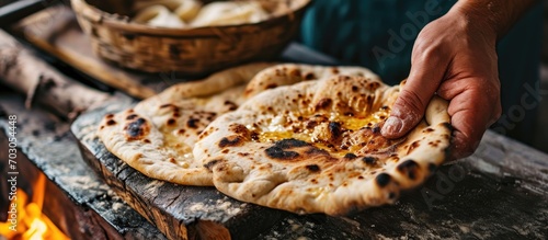 Removing cheese from a stuffed flatbread naan. photo
