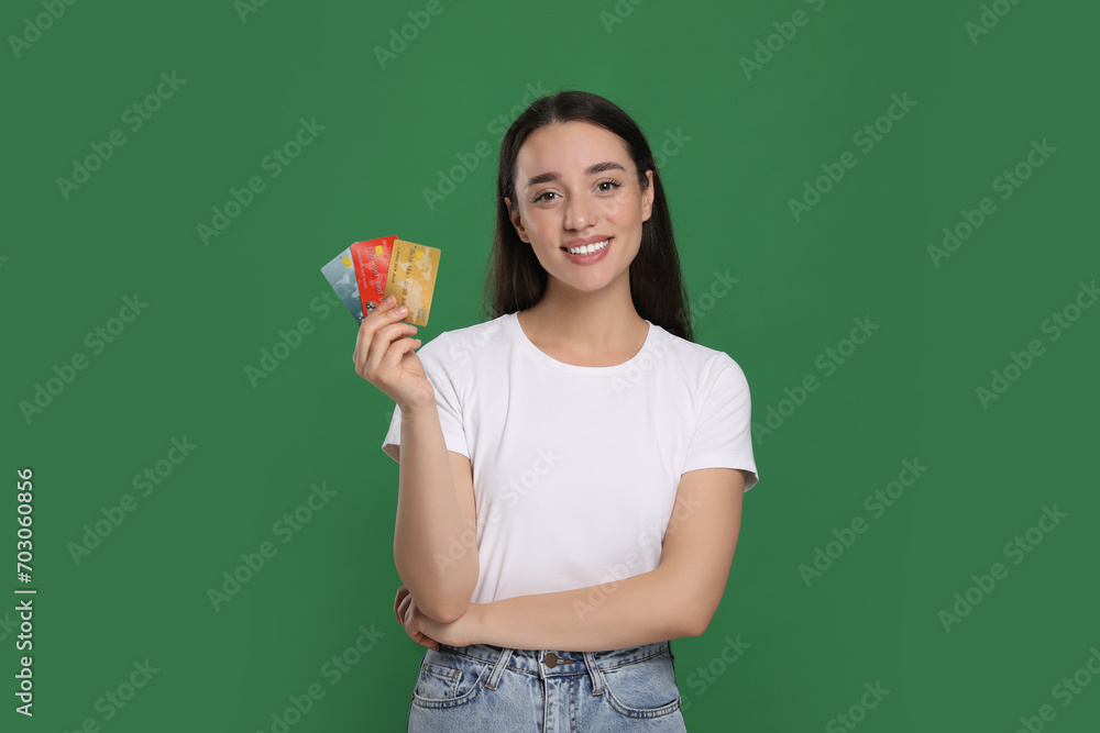 Happy woman with credit cards on green background. Debt free Happy woman with credit cards on green background. Debt free