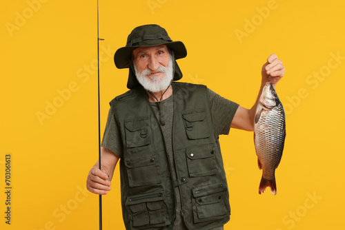 Fisherman with rod and catch on yellow background