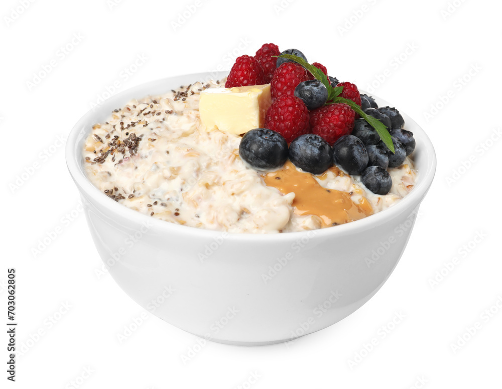 Tasty boiled oatmeal with berries, chia seeds and peanut butter in bowl isolated on white Tasty boiled oatmeal with berries, chia seeds and peanut butter in bowl isolated on white