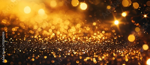 Festive golden background with glittery star particles, sparkling lights and confetti explosion. Ideal for Christmas sales.