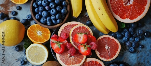 Bird s-eye view of assorted fruits  banana  blueberries  grapefruit  prepping for child s self-feeding.