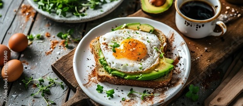Avocado and fried egg on toast with coffee, a nutritious morning option