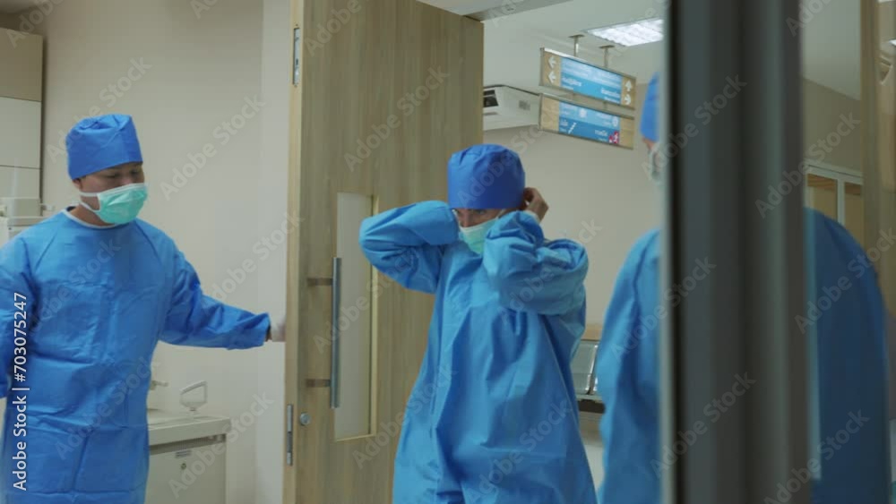 Professional doctors tying a surgical cap while walk into operating room. Professional doctors tying a surgical cap while walk into operating room.