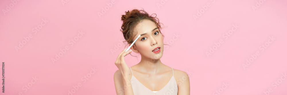 Young beautiful model with beauty face applying makeup. Young beautiful model with beauty face applying makeup.