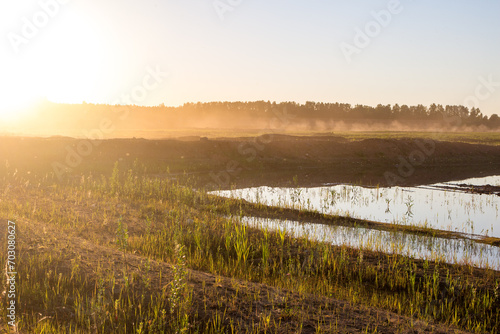 Heavy sand dust raised at an active sand quarry in the sun