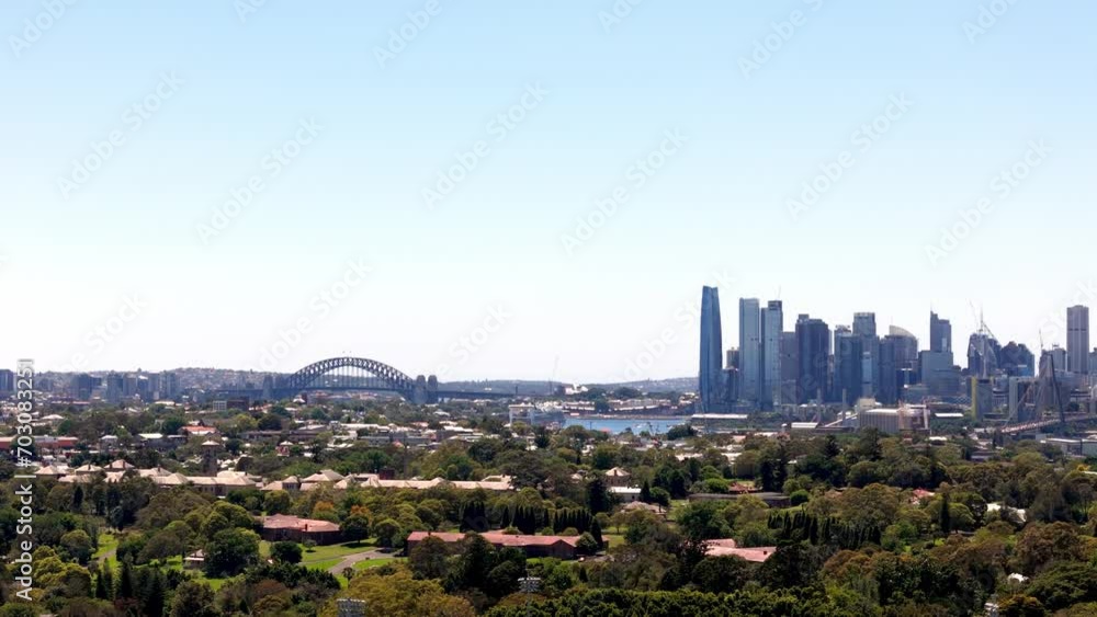 Expansive city skyline with iconic bridge, A panoramic view from a suburban vantage point Expansive city skyline with iconic bridge, A panoramic view from a suburban vantage point