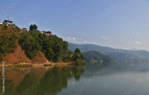 Views of the blue sky  rice fields  clear lake water and morning sunlight around Begnas Lake in Pokhara  Nepal.