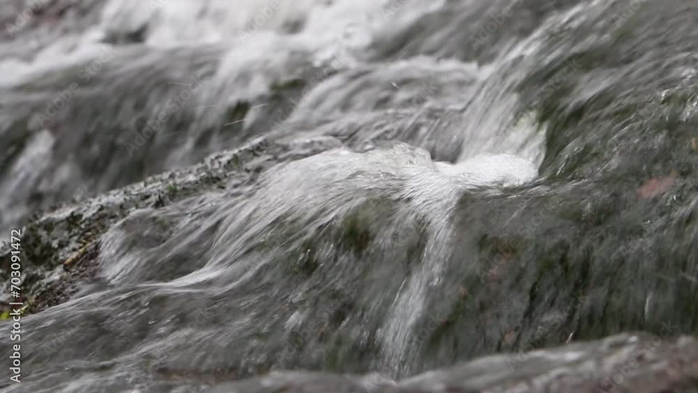 Water flowing over rocks in small stream. Winter. UK Water flowing over rocks in small stream. Winter. UK