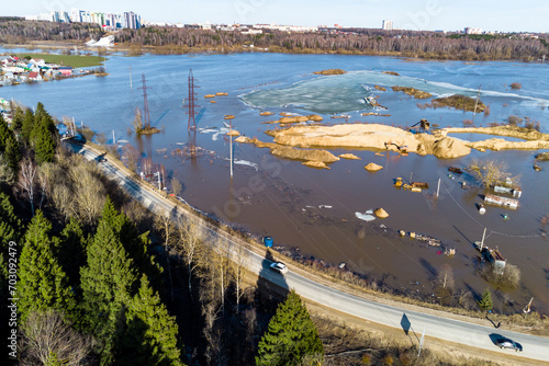 Aerial view from behind the forest to the area flooded during the spring flood