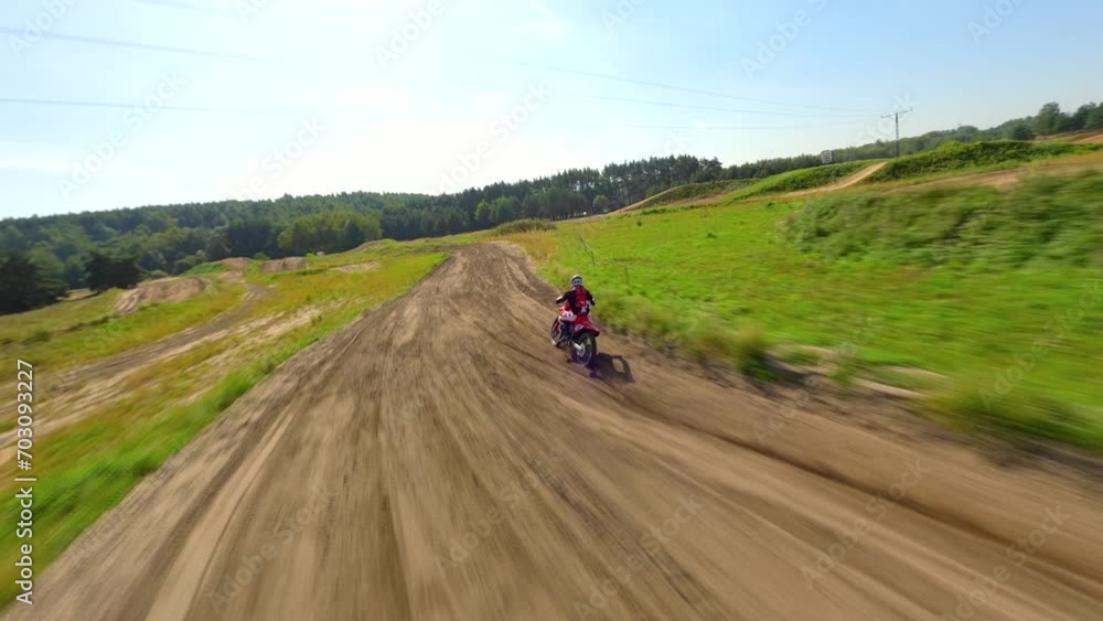 FPV of high-speed motocross bike on track. Concepts of extreme sports, racing, and adrenaline. FPV of high-speed motocross bike on track. Concepts of extreme sports, racing, and adrenaline.