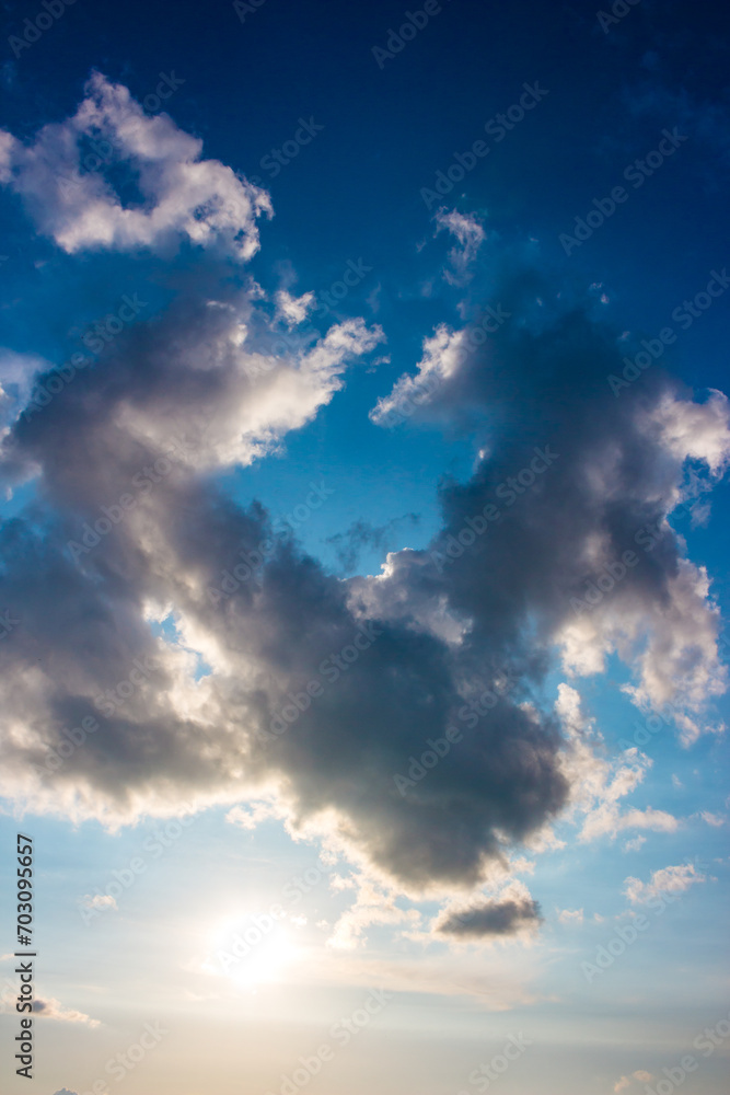 Obraz premium Ring shaped cloud on blue sky, vertical view