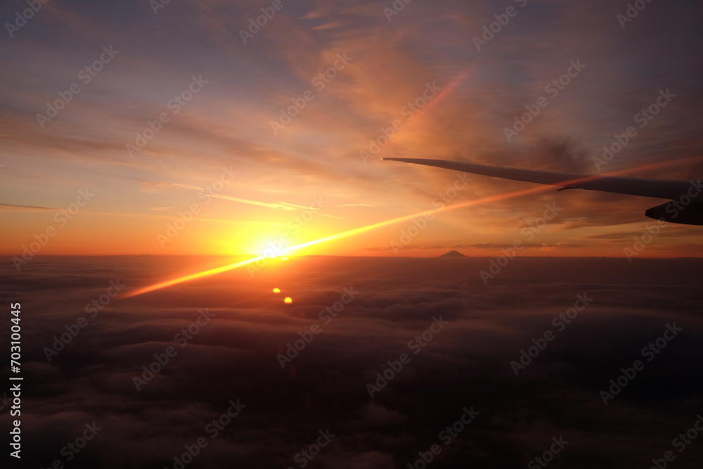 sunset or sunrise above the cloud with top of a mountain taking from a flight - 1