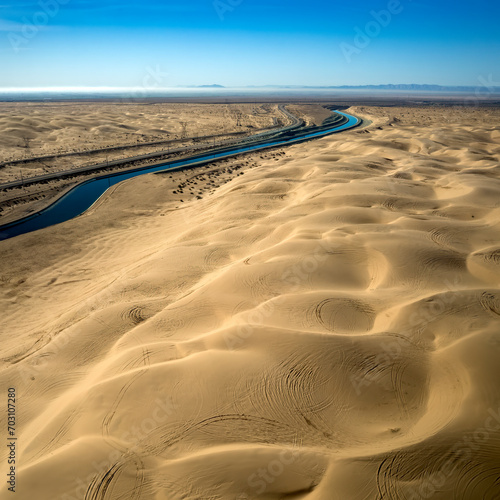 Dramatic aerial view of the all-American canal traveling through the Buttercup sand dunes in imperial county California. photo