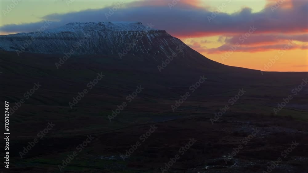 Low Light Establishing Drone Shot of Snowy Ingleborough at Sunset Low Light Establishing Drone Shot of Snowy Ingleborough at Sunset