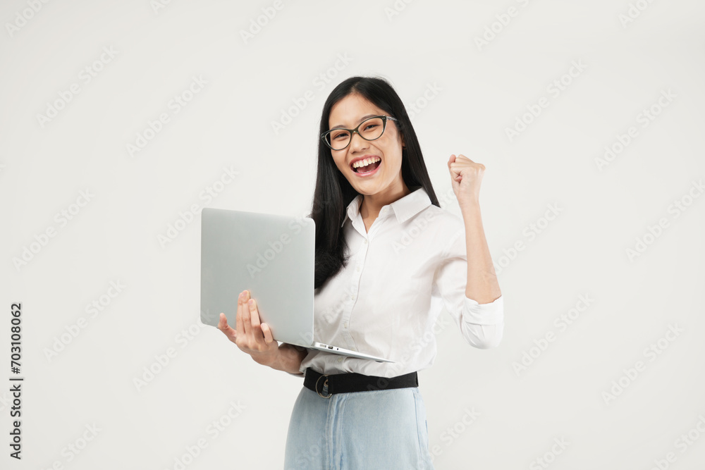 Photo of an Asian woman 20s standing and holding a laptop, dressed a white shirt and glasses, isolated on a white background. Student concept. Photo of an Asian woman 20s standing and holding a laptop, dressed a white shirt and glasses, isolated on a white background. Student concept.