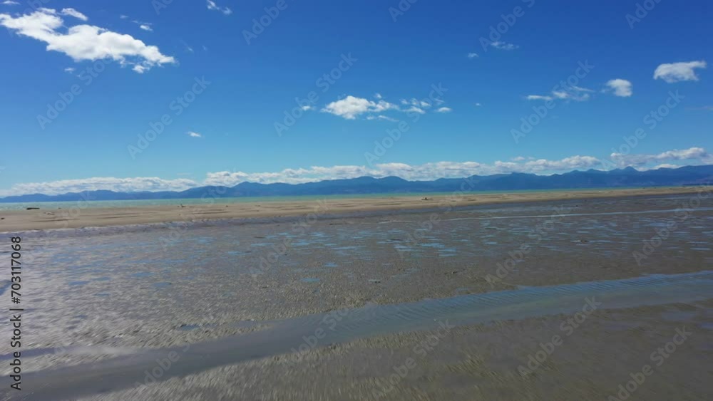 Sunny day flyover mudflats to sandbar veering to the right on a beautiful sunny day Sunny day flyover mudflats to sandbar veering to the right on a beautiful sunny day