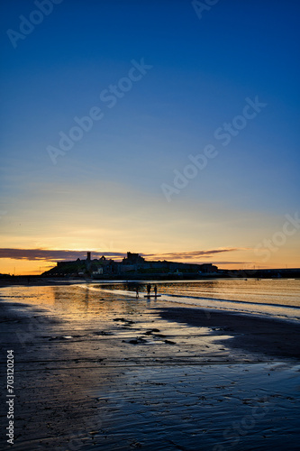 sunset with a castle at the beach in isle of man