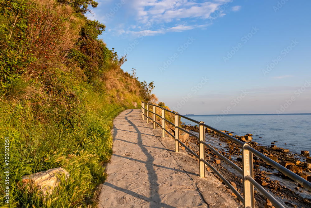 Scenic walking path between Fiesa and charming coastal town of Piran in Slovenian Istria, Slovenia, Europe. Rugged rocky cliffs gracefully perched above shimmering waters of the Adriatic Sea. Seascape
