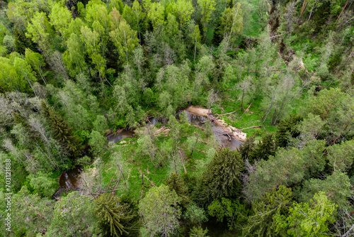 A small river Borinka flowing through a forest area, as seen from a drone. Borovsky district, Kaluga region, Russia