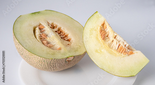 cantaloupe, melon slices on white dish