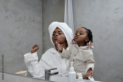 crazy young woman and her toddler having fun in the bathroom. close up shot, enteratinment. free time, lifestyle. happiness