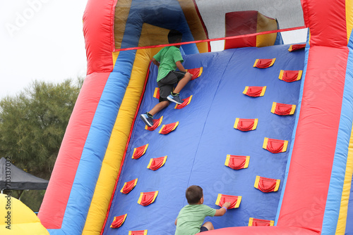 Картината върху платно A view of a children climbing an inflatable obstacle course.