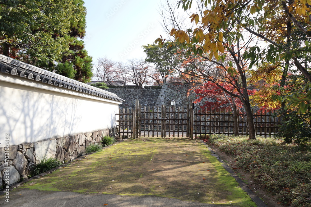 White walls, wooden fence and autumn leaves at Koko-en Garden in the early morning, Himeji, Japan White walls, wooden fence and autumn leaves at Koko-en Garden in the early morning, Himeji, Japan