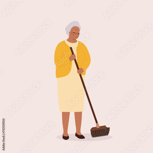 One Smiling Black Senior Woman Sweeping Floor With A Broom. Full Length.