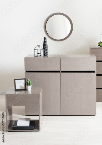 Sleek Modern Furniture Ensemble in a Stylish Bedroom Setting  Ash Wood Sideboard with Minimalist Handles  Matching Side Table Featuring a Small Framed Mirror  Candle Holder  and a Round Frame Mirror.