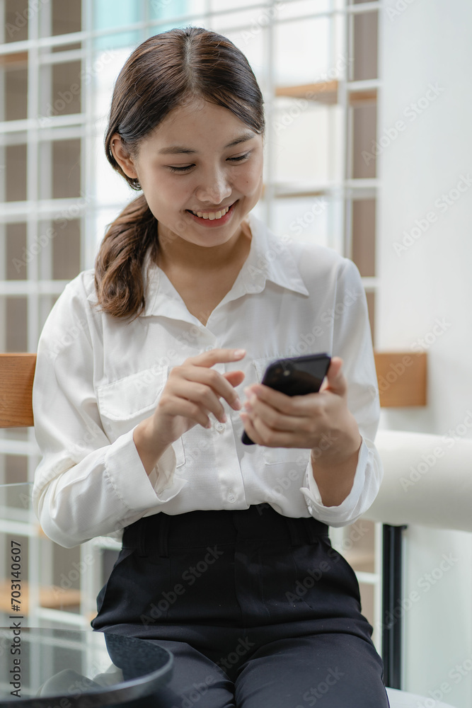 Cute Asian woman using smartphone in her hand, technology concept and people Surfing the internet and shopping online. Vertical image. Cute Asian woman using smartphone in her hand, technology concept and people Surfing the internet and shopping online. Vertical image.