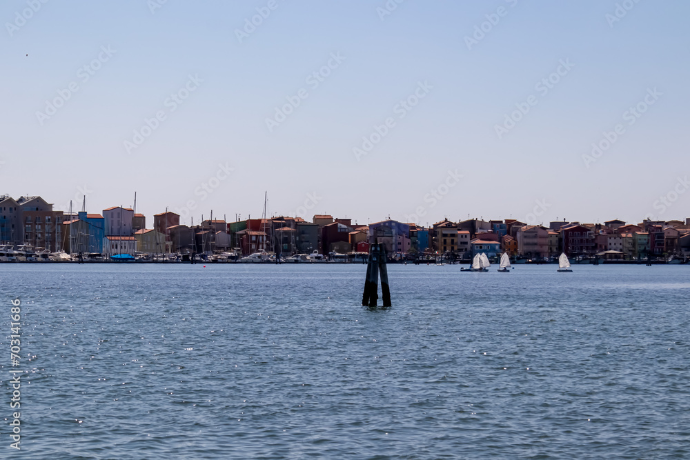 Sailing boat regatta in the picturesque bay nestled between the idyllic towns of Chioggia and Sottomarina, located in the captivating Venetian Lagoon of Veneto, Italy. Vacation Mediterranean sea