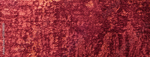Texture of velvet dark red background from a soft upholstery textile material. Abstract velour wine fabric photo