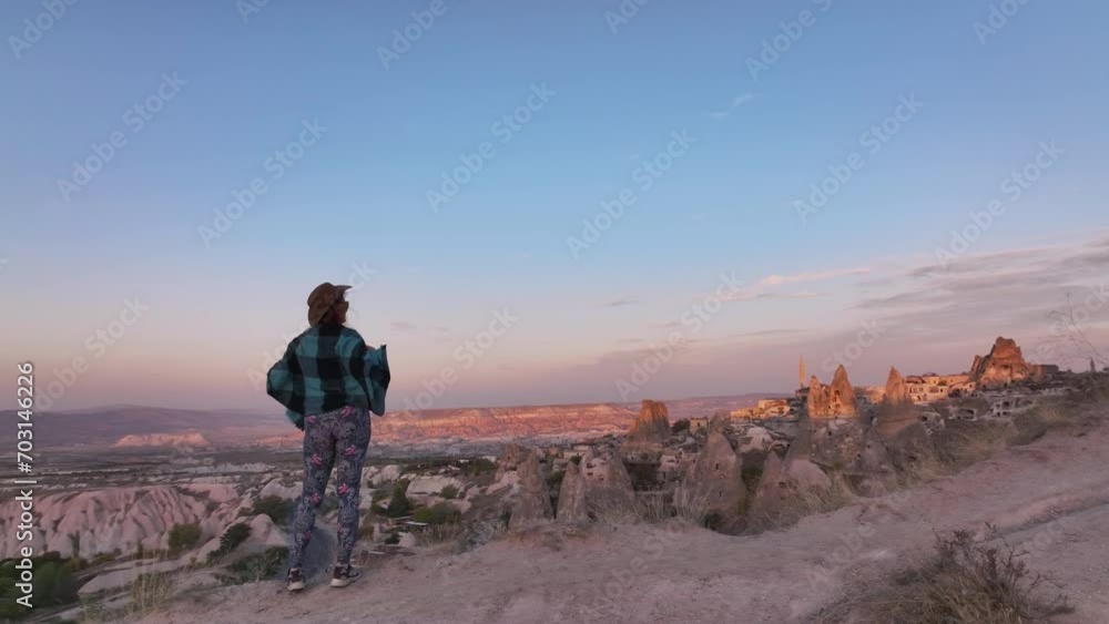 A Girl Traveler In A Hat, In The Valley Of Cappadocia At Sunset A Girl Traveler In A Hat, In The Valley Of Cappadocia At Sunset