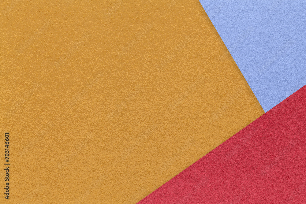 Texture of craft dark yellow color paper background with blue and red border. Vintage abstract orange cardboard. Texture of craft dark yellow color paper background with blue and red border. Vintage abstract orange cardboard.