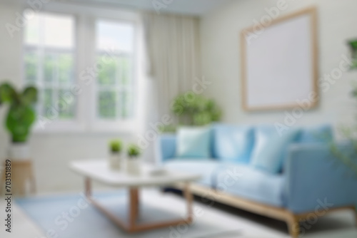 Blurred view of modern living room with sofa and soft bench 