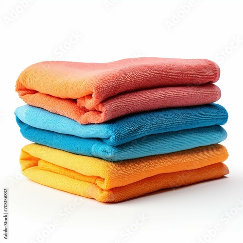 Stack of colorful towels isolated on white background. Clipping path included.
