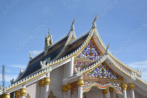 Beautiful temple roof against blue sky in Thailand © winai