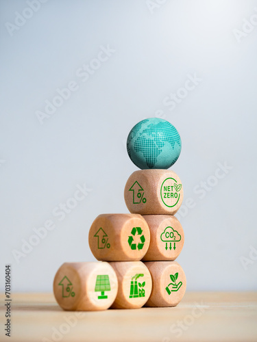 Reduce CO2 emissions, limit climate change, global warming, net zero carbon dioxide reduction concept. 3d earth on wood cube stack as a graph with words 