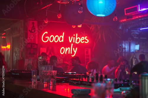 Good vibes only concept image with glowing written words good vibes only in a nightclub with a DJ to show a positive ambiance and attitude photo